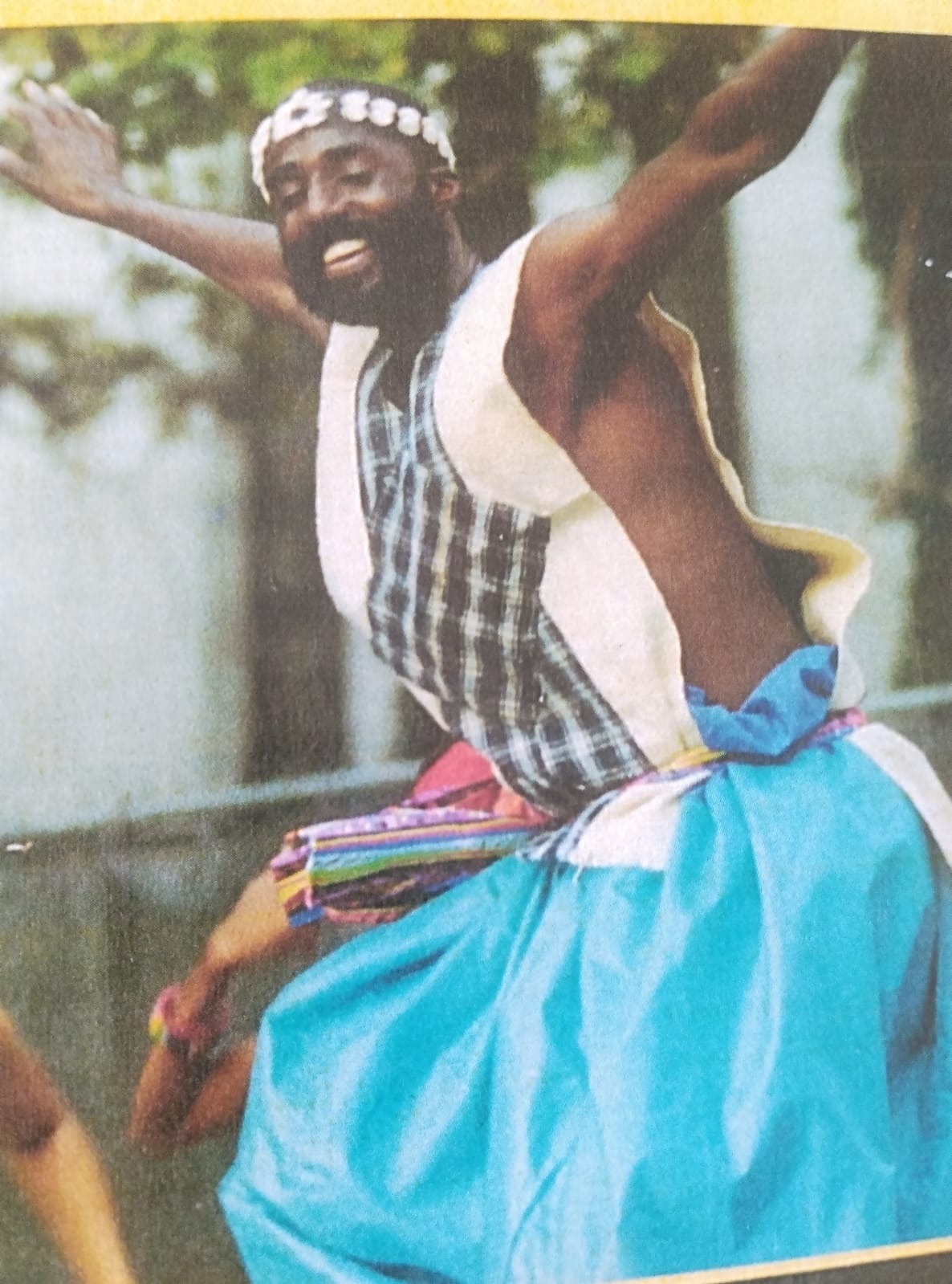 A joyous, dynamic performance scene where a dancer radiates happiness. Surrounding them are vivid, swirling colors and abstract forms representing joy, with the audience visibly engaged and inspired. The backdrop reflects a blend of nature and cosmic elements, symbolizing timeless celebration.